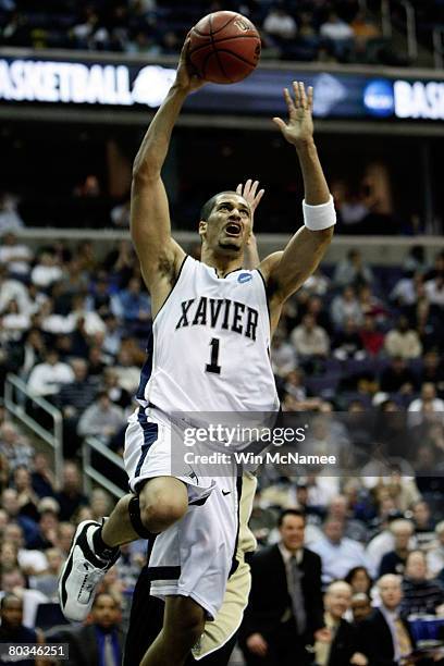 Josh Duncan of the Xavier Musketeers goes to the hoop against the Purdue Boilermakers during the second round of the West Regional as part of the...