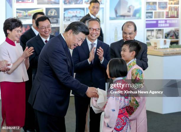 June 29, 2017 -- Chinese President Xi Jinping talks with children who performed Cantonese opera while attending a signing ceremony for cooperation...