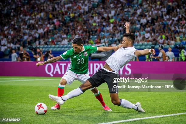 Benjamin Henrichs of Germany tackles Javier Aquino of Mexico during FIFA Confederations Cup Russia semi-final match between Germany and Mexico at...