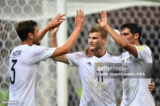 Timo Werner of Germany celebrates scoring his side's third goal with his team mates Jonas Hector and Lars Stindl of Germany during the FIFA...