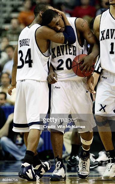 Stanley Burrell and C.J. Anderson of the Xavier Musketeers celebrate towards the end of their game against the Purdue Boilermakers during the second...