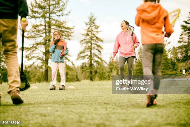 family playing lacrosse - lacrosse stock pictures, royalty-free photos & images