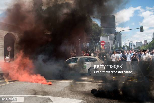 Taxi covered with smoke during a protest against Uber and Cabify demanding government to obey law, demanding just one Uber per 30 taxis.