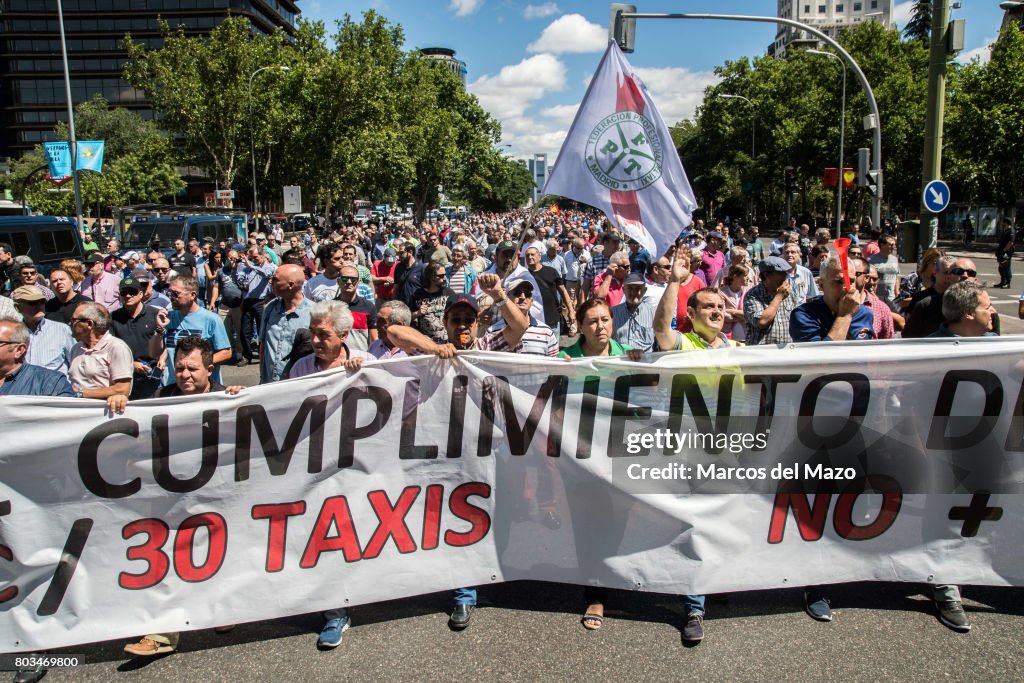 Taxi drivers protesting against Uber and Cabify demanding...