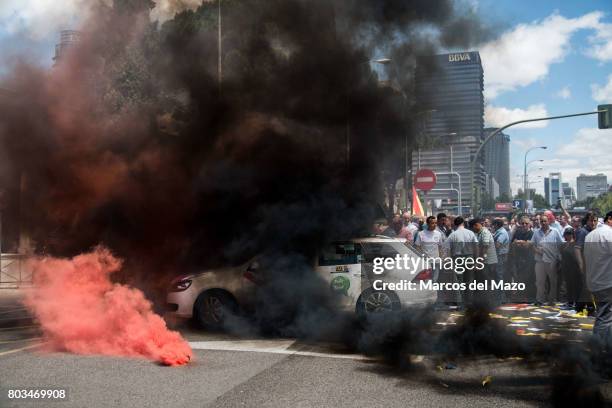 Taxi covered with smoke during a protest against Uber and Cabify demanding government to obey law, demanding just one Uber per 30 taxis.
