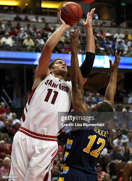 Brook Lopez of the Stanford Cardinal shoots over the defense of Dwight Burke of the Marquette Golden Eagles during the South Region second round of...