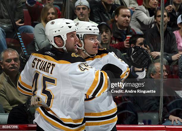 Petteri Nokelainen of the Boston Bruins celebrates his second period goal against the Montreal Canadiens with teammate Mark Stuart at the Bell Centre...