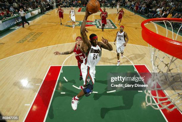 Desmond Mason of the Milwaukee Bucks attempts a dunk and is fouled by Delonte West of the Cleveland Cavaliers at the Bradley Center March 22, 2008 in...