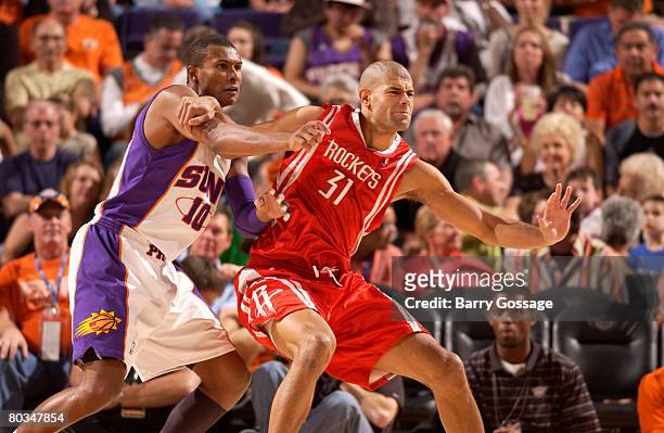 Shane Battier of the Houston Rockets battles for positions with Leandro Barbosa of the Phoenix Suns in an NBA game played at U.S. Airways Center...