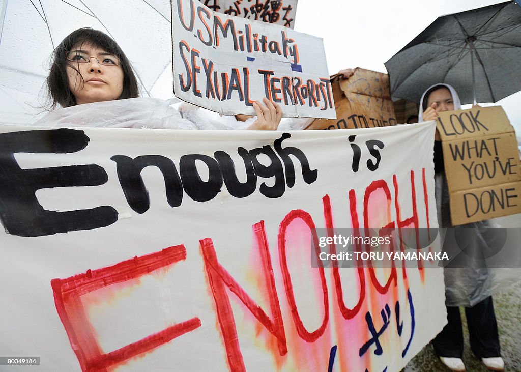 Young Japanese women hold banners during