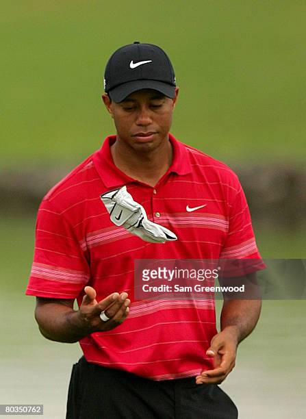 Tiger Woods of the USA tosses his glove during the completion of the third round of the World Golf Championships CA Championship at the Doral Golf...