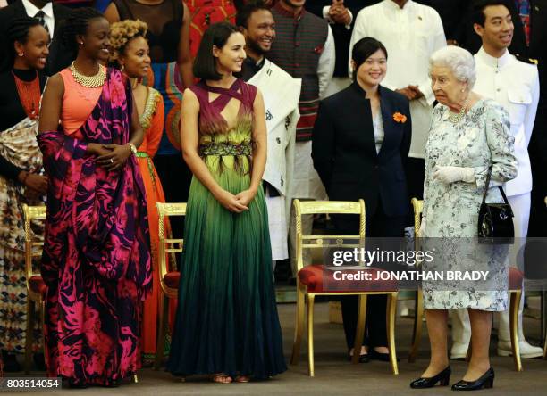 Britain's Queen Elizabeth II departs after posing for a group photo at the Queen's Young Leaders Awards ceremony at Buckingham Palace in London on...