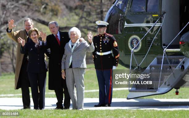 President George W. Bush waves along with his father, former US President George H.W. Bush , First Lady Laura Bush and his mother, Barbara Bush after...