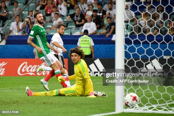 Germany's midfielder Amin Younes scores in the nets of Mexico's goalkeeper Guillermo Ochoa during the 2017 Confederations Cup semi-final football...