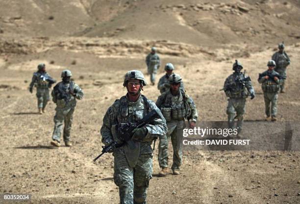 Soldiers from Ghostrider Company 3rd Squadron 2nd Stryker Cavalry Regiment patrol through the desert as they hunt for caves and tunnels used by...