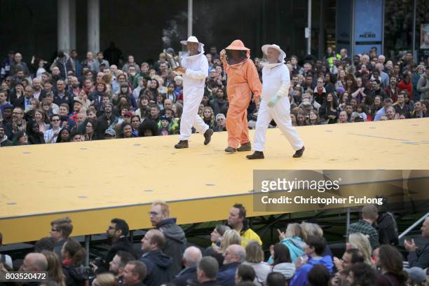 Bee keepers parade on a 100m long catwalk installed high above the ground as part of What Is The City But The People? show in Piccadilly Gardens on...