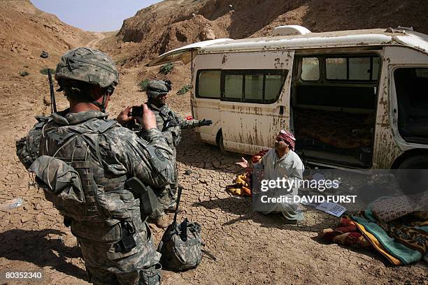 Soldiers from Ghostrider Company 3rd Squadron 2nd Stryker Cavalry Regiment photograph an Iraqi man with alleged links to Sunni insurgent groups in...
