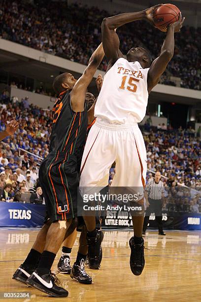 Alexis Wangmene of the Texas Longhorns goes up to shoot over James Dews of the Miami Hurricanes during the second round of the South Regional as part...