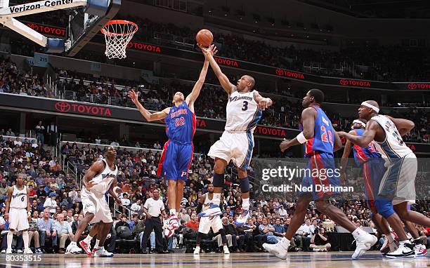 Caron Butler of the Washington Wizards shoots against Tayshaun Prince of the Detroit Pistons at the Verizon Center on March 23, 2008 in Washington,...