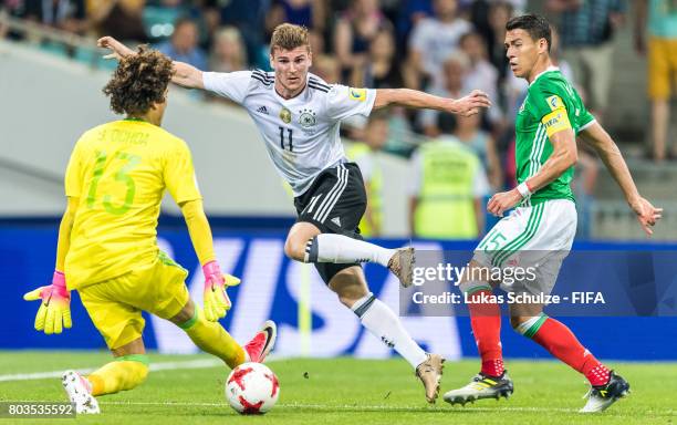 Timo Werner of Germany, Goalkeeper Guillermo Ochoa of Mexico and Hector Moreno of Mexico fight for the ballduring the FIFA Confederations Cup Russia...