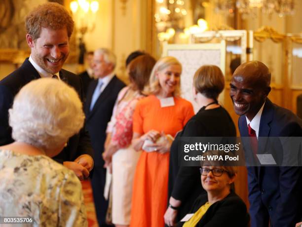 Queen Elizabeth II and Prince Harry greet Dame Tanni Grey-Thompson and Sir Mo Farah during the 2017 Queen's Young Leaders Awards Ceremony at...