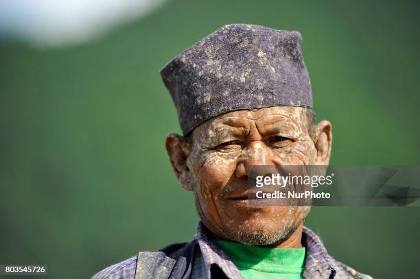 Mud covered Portrait of 65yrs old, RATNA BAHADUR NAGARKOTI after plowing paddy field using ox for the rice plantation during the celebration of...