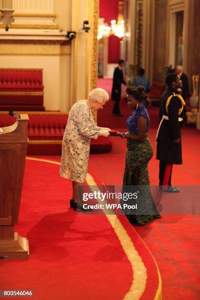 Miss Ruth Nabembezi from Uganda receives a Queen's Young Leaders Award for 2017 from Queen Elizabeth II at the 2017 Queen's Young Leaders Awards...