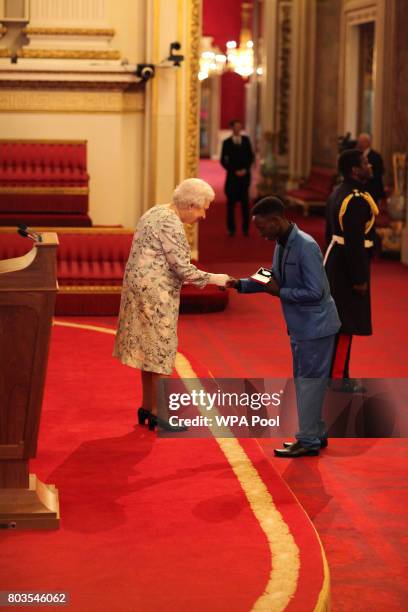 Mr. Joel Baraka from Uganda receives a Queen's Young Leaders Award for 2017 from Queen Elizabeth II at the 2017 Queen's Young Leaders Awards Ceremony...