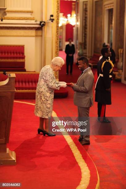 Abrahim Simmonds from Jamaica receives a Queen's Young Leaders Award for 2017 from Queen Elizabeth II at the 2017 Queen's Young Leaders Awards...