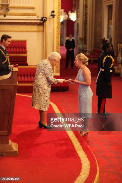 Miss Ashleigh Smith from New Zealand receives a Queen's Young Leaders Award for 2017 from Queen Elizabeth II at the 2017 Queen's Young Leaders Awards...