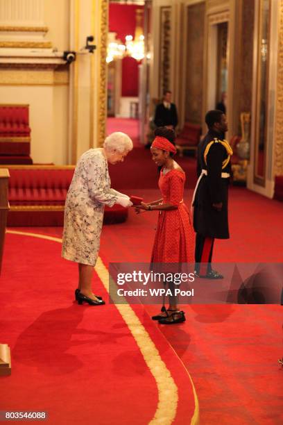 Miss Chaikhwa Lobatse from Botswana receives a Queen's Young Leaders Award for 2017 from Queen Elizabeth II at the 2017 Queen's Young Leaders Awards...