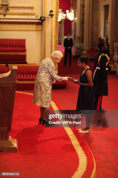 Ms Theresa Gizoria from Papua New Guinea receives a Queen's Young Leaders Award for 2017 from Queen Elizabeth II at the 2017 Queen's Young Leaders...