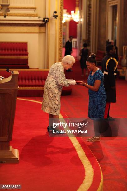 Miss Karrie Jionisi from Solomon Islands receives a Queen's Young Leaders Award for 2017 from Queen Elizabeth II at the 2017 Queen's Young Leaders...