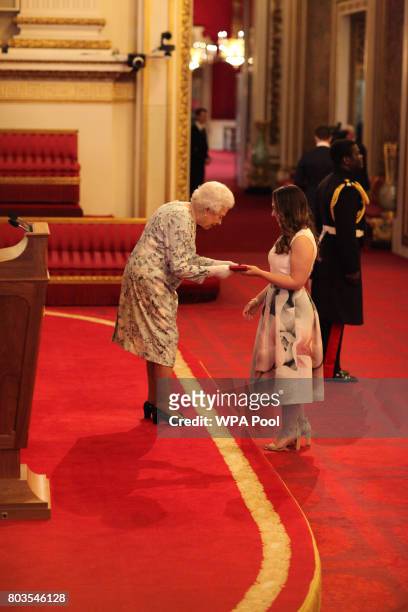Miss Madeleine Buchner from Australia receives a Queen's Young Leaders Award for 2017 from Queen Elizabeth II at the 2017 Queen's Young Leaders...