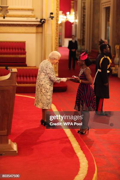 Miss Kumba Musa from Sierra Leone receives a Queen's Young Leaders Award for 2017 from Queen Elizabeth II at the 2017 Queen's Young Leaders Awards...