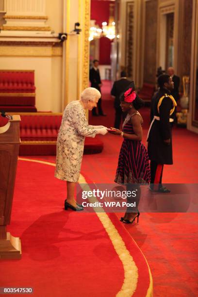 Miss Kumba Musa from Sierra Leone receives a Queen's Young Leaders Award for 2017 from Queen Elizabeth II at the 2017 Queen's Young Leaders Awards...