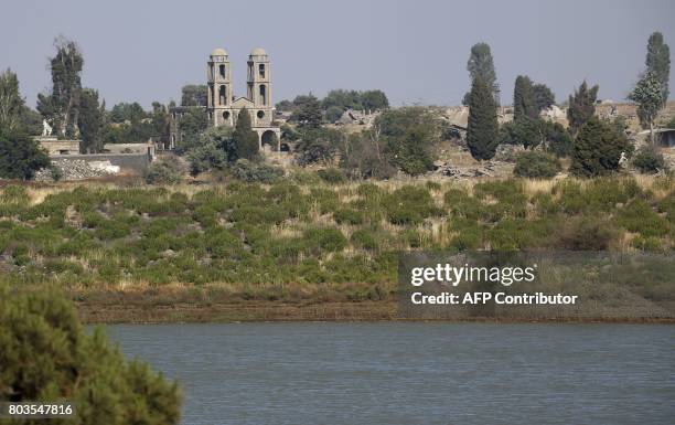 Picture taken from the Israeli side of the occupied Golan Heights shows a church, destroyed during the 1967 war, in the Syrian border town of...