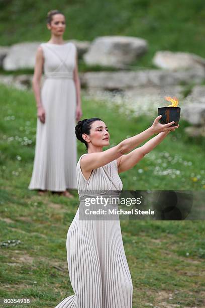 High Priestess" Maria Nafpliotou raises the Archaic Pot in the Ancient Stadium during the Lighting Ceremony of the Olympic Flame, at Ancient Olympia...