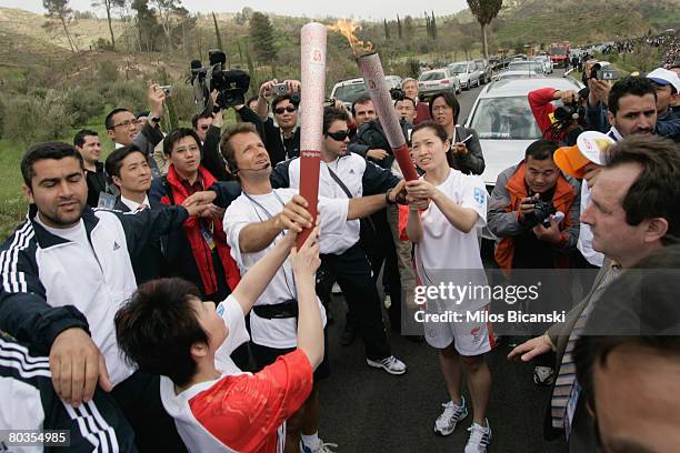 Deng Yaping and Luo Xuejuan the Chinese torchbearers during the Lighting Ceremony of the Olympic Flame at Ancient Olympia on March 24, 2008 in...