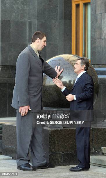 President of Ukraine Viktor Yushchenko speaks to Leonid Stadnik who at 2.59 metres tall, is the world's tallest living man, at the Presidential...