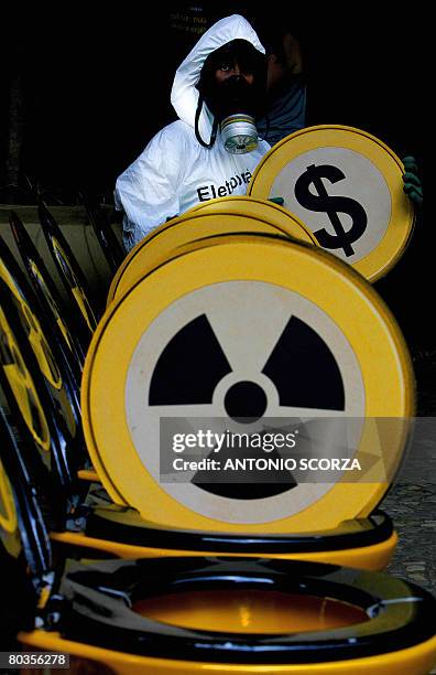 Greenpeace activist demonstrates by sitting on one of several toilets placed at the entrance of the headquarters of the power company Eletrobras, on...