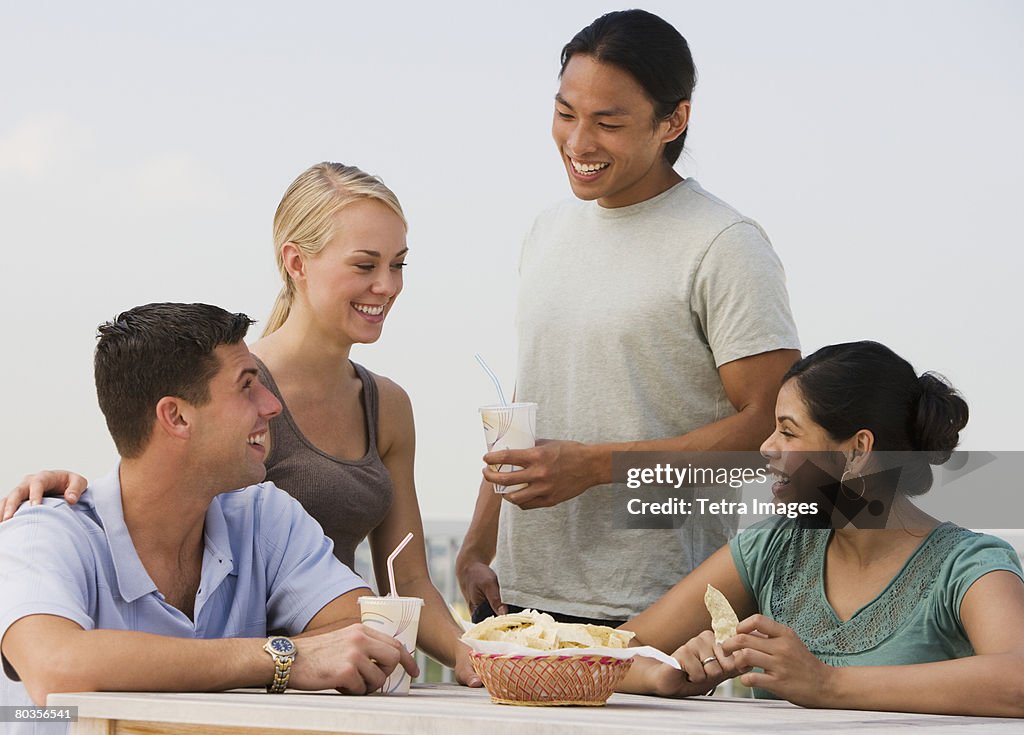 Multi-ethnic friends eating 
