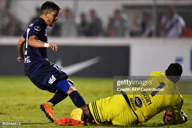 Ernesto Alvarez of Paraguay's Sol de America vies for the ball with goalkeeper Aranha of Brazils Ponte Preta during their 2017 Copa Sudamericana...