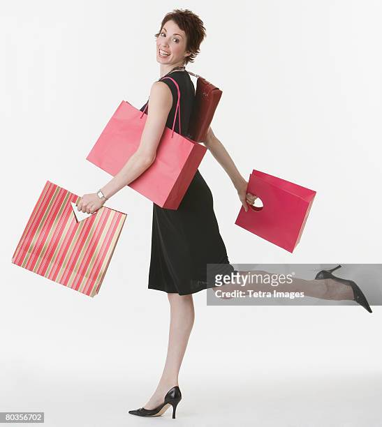 woman carrying shopping bags - shopping bags white background stock pictures, royalty-free photos & images