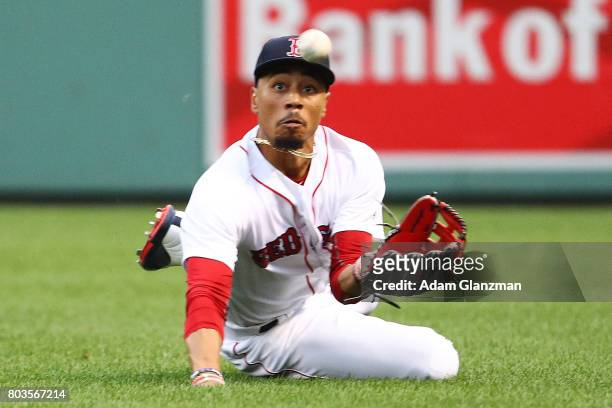 Mookie Betts of the Boston Red Sox makes a diving catch in the second inning of a game against the Minnesota Twins at Fenway Park on June 29, 2017 in...