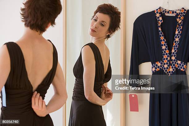 woman zipping back of dress - evening gown stock-fotos und bilder