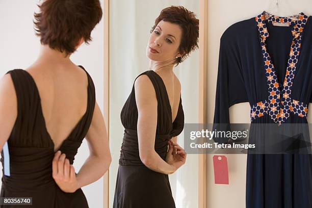 woman zipping back of dress - woman in evening dress stock pictures, royalty-free photos & images