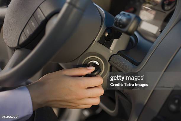 woman turning car key in ignition - turning key stock pictures, royalty-free photos & images