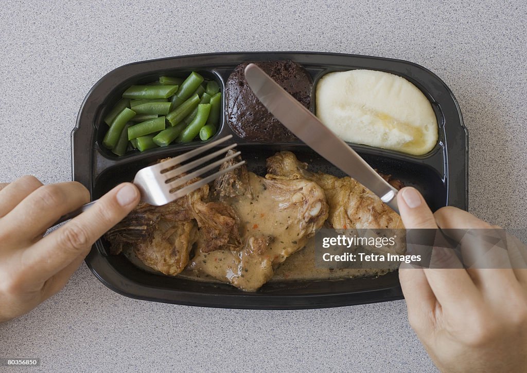 Man eating TV dinner