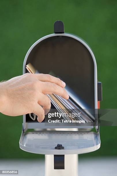 man taking mail out of mailbox - domestic mailbox stock-fotos und bilder